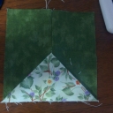 This is the first block that I did for the border. Ricky had a video that showed just the flying geese with the fast way in month 12 video. well I sandwiched the  light colored fabric that is folded 4 1/2 x 2 1/2 between the green 4 1/2 x 2 1/2 . now I have my border with only one seam.