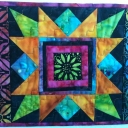 Geneva - I<br /> drafted the center block from Jinny Beyer's book of blocks. (I finally found and unpacked it!) The block is called "Memory". I used left overs from my 2009 TQS BOM on the sides. My little quilt reminds me how much I have gained being a member