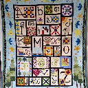 I'm so excited - I finished and it's only January 2015! I used quilt-as-you-go on this and made a couple of bad decisions, particularly where the blue border seams are, but overall I am very happy.  I loved quilting the lower-case letters in the border, and had a blast circling the polka dots.  My husband loves the quilt and has already napped with it wrapped around him.  Mission accomplished!