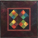 "Primitive Four-Patches" by Ricky Tims, La Veta, Colorado. If you go with simple piecing or simple appliqué, make the quilt exciting by adding rich quilting or other embellishments.