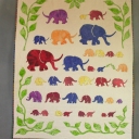 Elephants - Appliqued elephants with a border of appliqued green leaves. There is a small amount of machine quilting under each row of elephants.