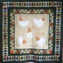 Here Come The Girls - Hand appliqued hens with hand embroidered foliage. Hens designed from photos of the real girls who don\'t actually lay that many eggs. Given as a gift to family members who keep hens.