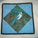 Bluejay Eating a Red Berry - A splash of color in a little wall quilt.