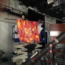 Hanging the background quilts behind the audience area.