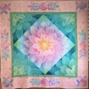 Grandmother’s Feather Quilt was made using 3 Hoffman Dream Big panels. The square in a square center used 2 panels. It was inspired by a similar quilt I saw on the Internet. I added 2 borders to make it larger and added appliqué flowers using a 3rd panel.