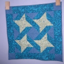 I made this wallhanging in 2004 from fabrics in my stash so that I could practice machine quilting, which I was just learning. It hangs in my spare bedroom.