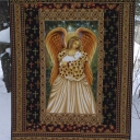 Dolores - I decided to make this quilt as a quick Christmas gift for my mom who collects angels. I used a wool batting to make it comfortable when watching TV and to make the angel pop out like trapunto. It ended up not being such a quick gift as there is fairly dense stitching in the borders that took me almost 2 months to complete. I also added crystals to make it sparkle.