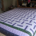 This was my first completed quilt. I quilted it on my domestic machine with SID, freehand flowers in the blocks and freehand leaves in each of the borders. It was quilted with invisible thread. I still sleep with this quilt.