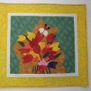 Take Time to Smell the Flowers - Made from a kit in 2010. This was my first quilt with freehand feathers, pebbles and heavy background quilting. I used green thread in the yellow border to tone it down. It now hangs in my livingroom.