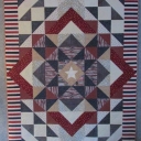 Hero Star - This is a Quilt of Valor I created from my improvisational "Star and Points Spinning in a Square". I used 100% quilter\'s cotton Valor fabric, 80/20 Hobbs batting, Omni poly wrapped poly by Superior Threads for the longarm. Design is totally 6" squares and half square triangles.