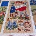 All Things Texas - The center panel is a printed Texas design. The side panels are representative of the windmills and wildflowers of Texas. Quilted to make the Texas icons pop in 3D, this quilt is meant to be a wall hanging and was a thank you gift for a neighbor.