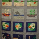 Scott\'s Beach Quilt - Our family has always loved to go to the beach. I started out to make a sailboat quilt, but it evolved. The pieced fish blocks came from Quilter\'s Newsletter Magazine Apr 1987. The fish, birds and other applique ideas were sketched from my children\'s various coloring books.